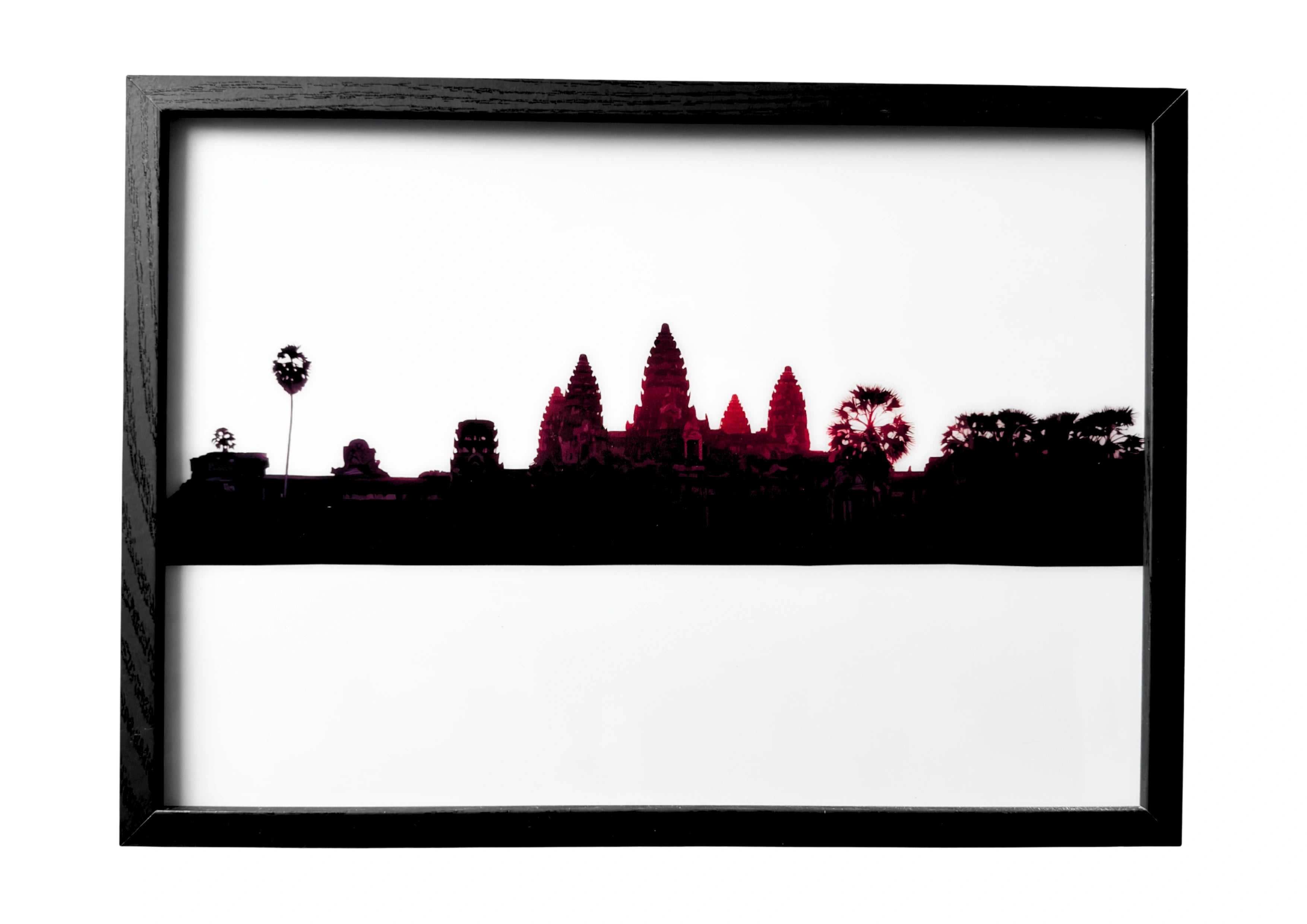 Angkor Wat wall art in peaceful silhouette — temple spires resting over dark still waters at dusk.