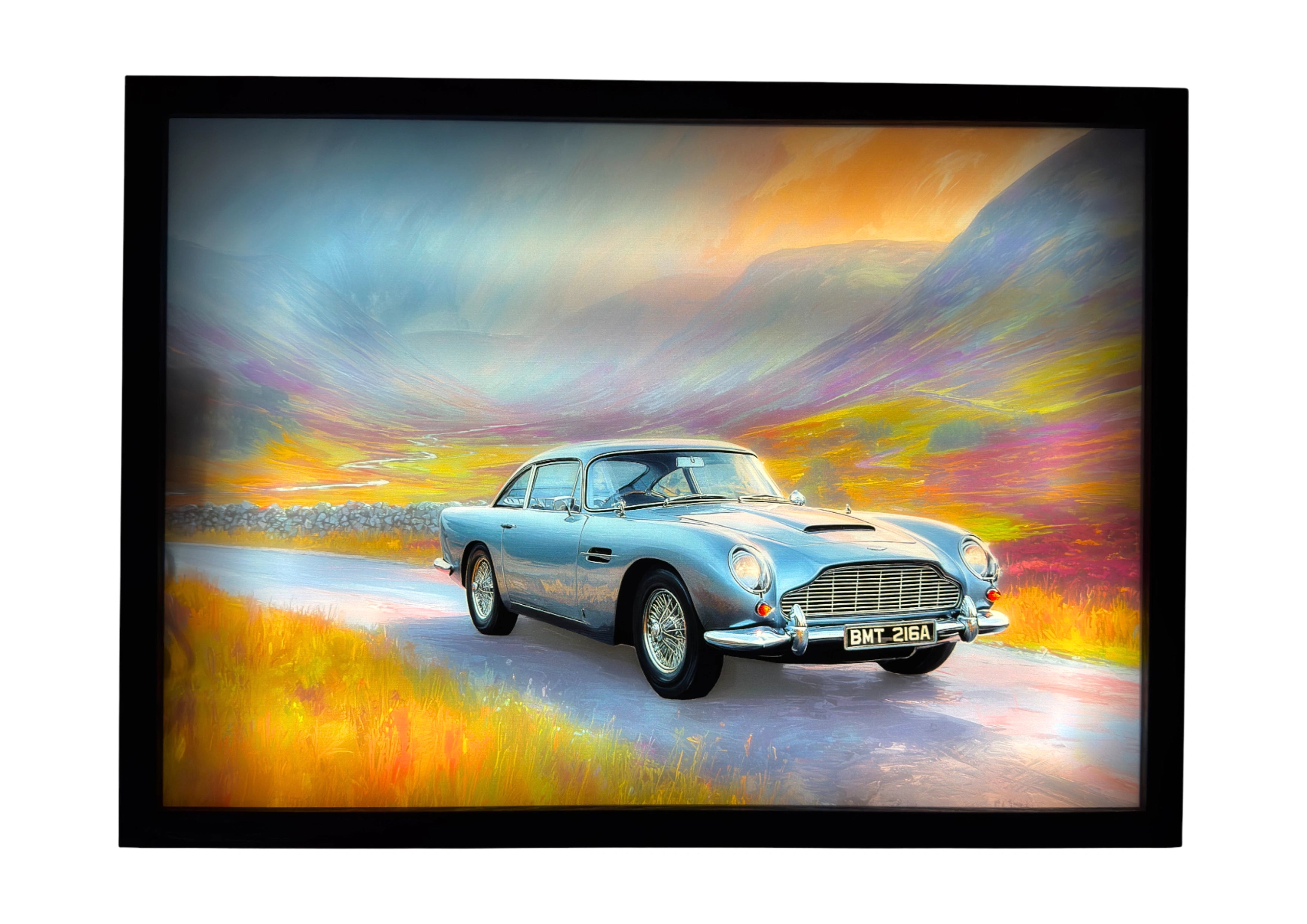 Aston Martin DB5 LED light up wall art glowing across a Highland road in amber and blue tones — a nod to Bond’s Goldfinger legacy.